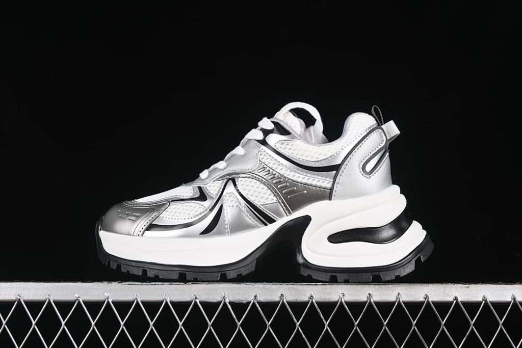 Side view of silver, white, and black GCDS G24X4338 chunky sneakers