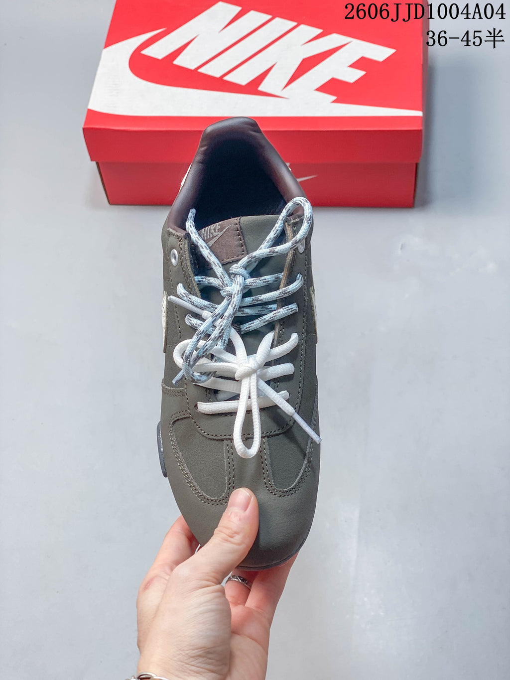 Top view of a gray Nike Sprint Sister sneaker with contrasting lace colors