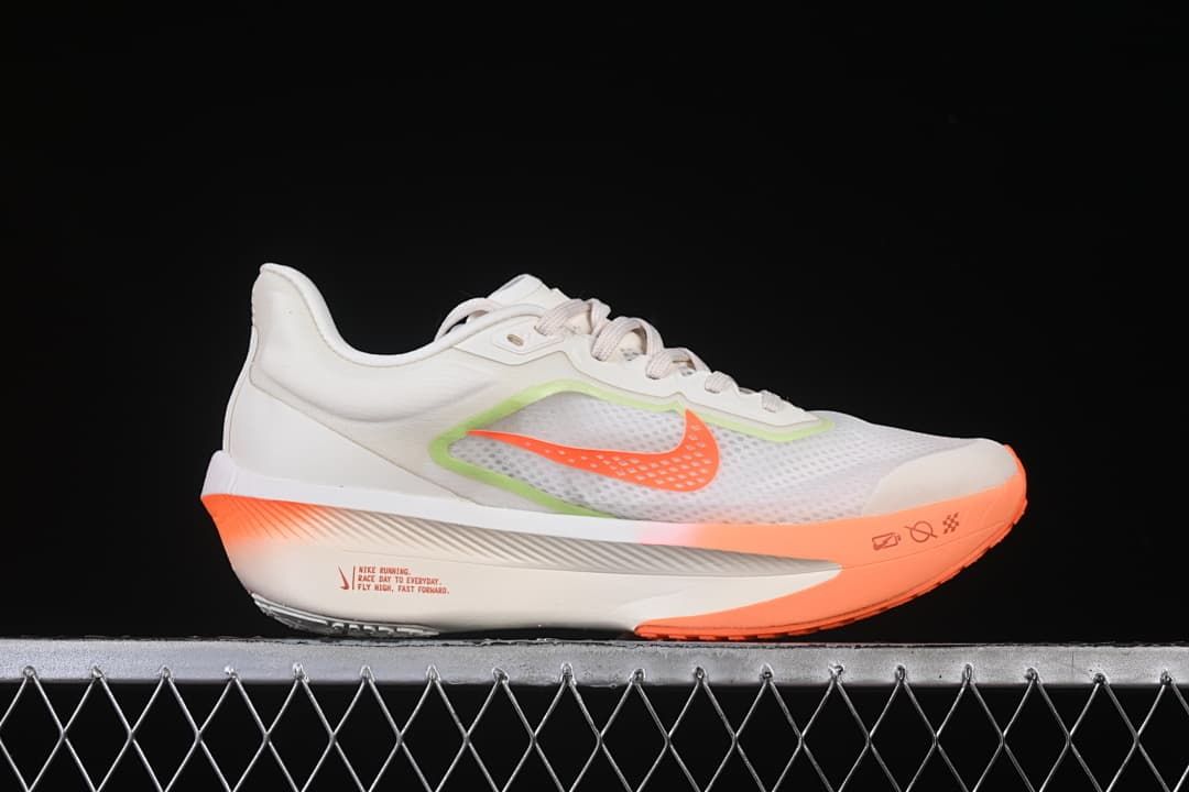 Side profile of the shoe with orange accents and a sculpted midsole.