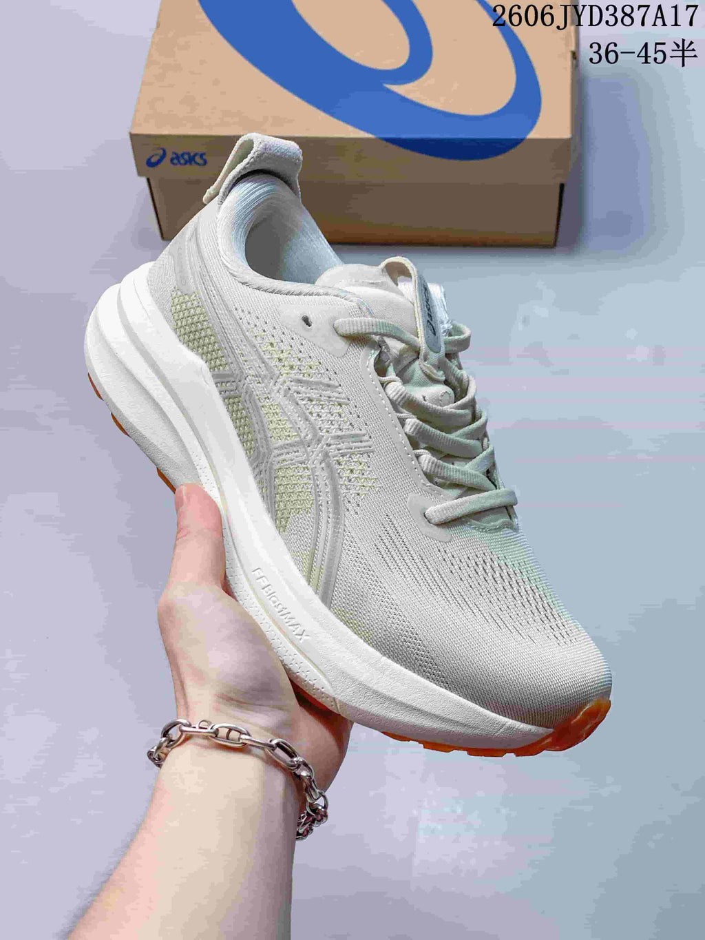 Side view of the ASICS running shoe with visible FF BLAST MAX marking and orange outsole accents