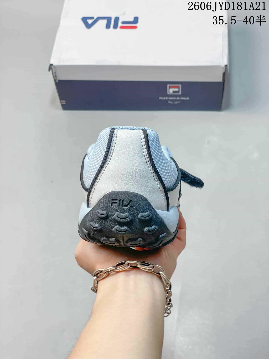 Rear view of the light blue and white sandal, showing the heel and outsole.
