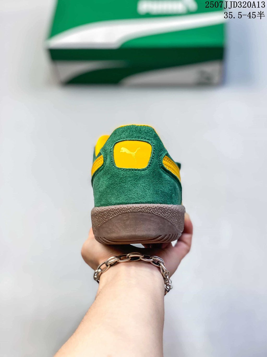 Rear view of a green PUMA sneaker with yellow collar detail and brown sole.