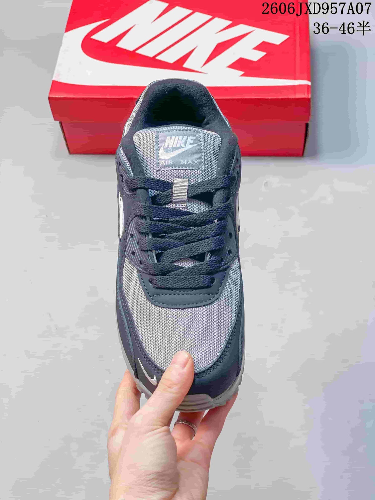 Top view of a navy and gray Nike Air Max 90 sneaker showing the laces and mesh toe.
