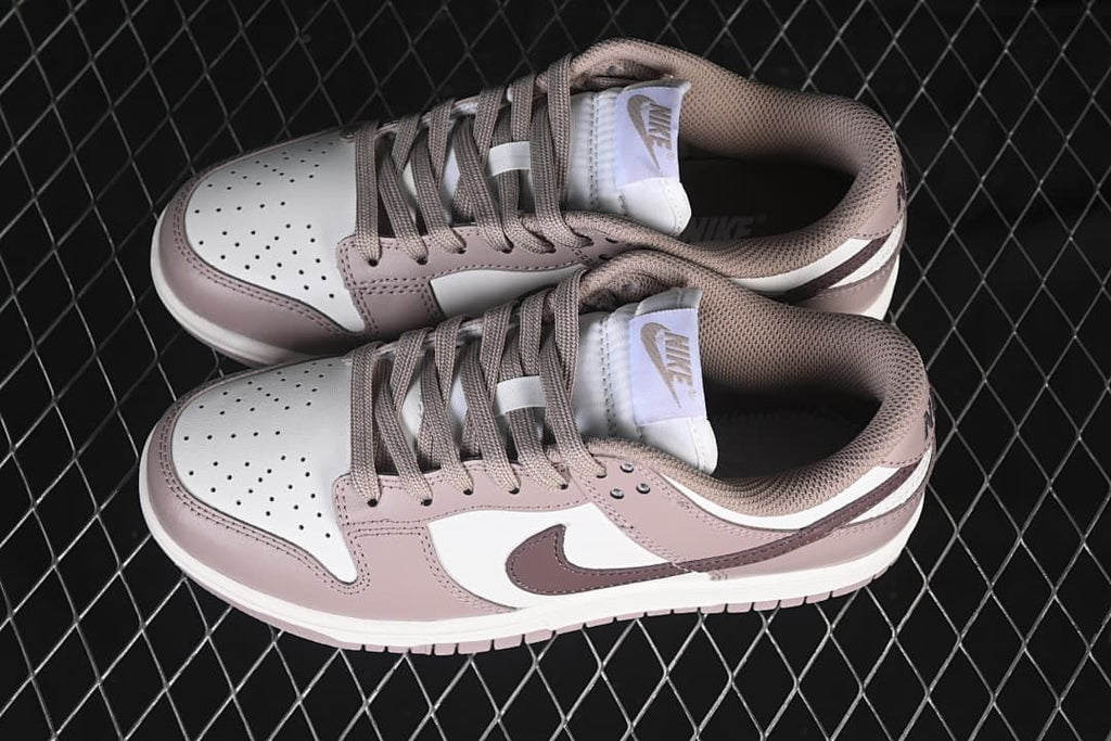 Pair of pink and white low-top sneakers viewed from above.