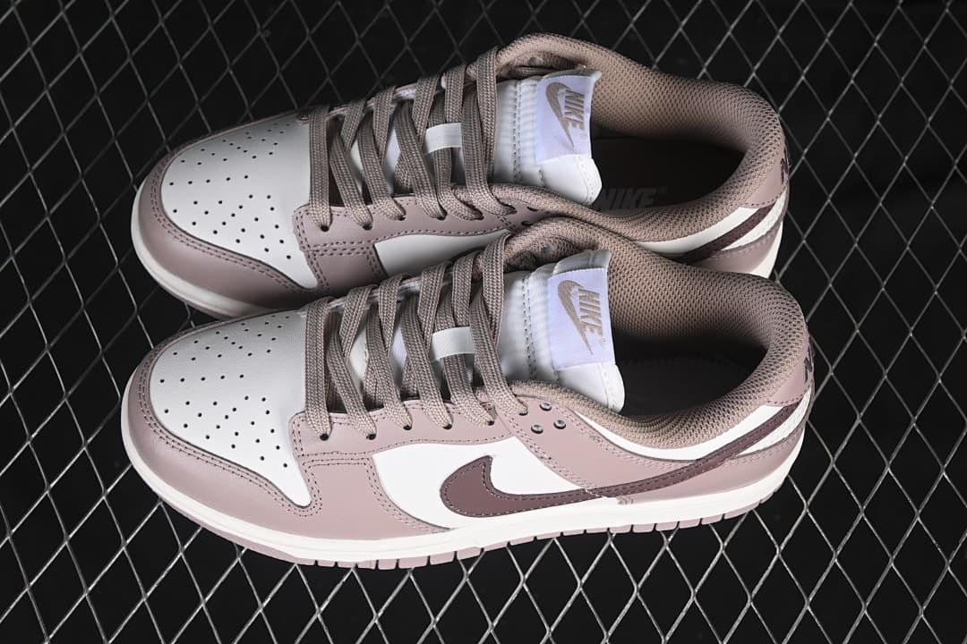 Pair of pink and white low-top sneakers viewed from above.