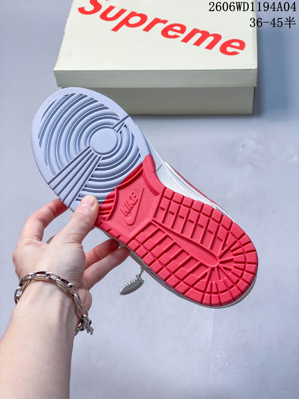 Close-up of the sneaker outsole with gray and red tread sections