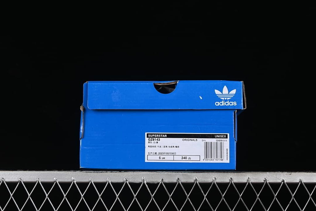 Blue adidas shoe box with a label identifying Superstar GZ8143 and sample size