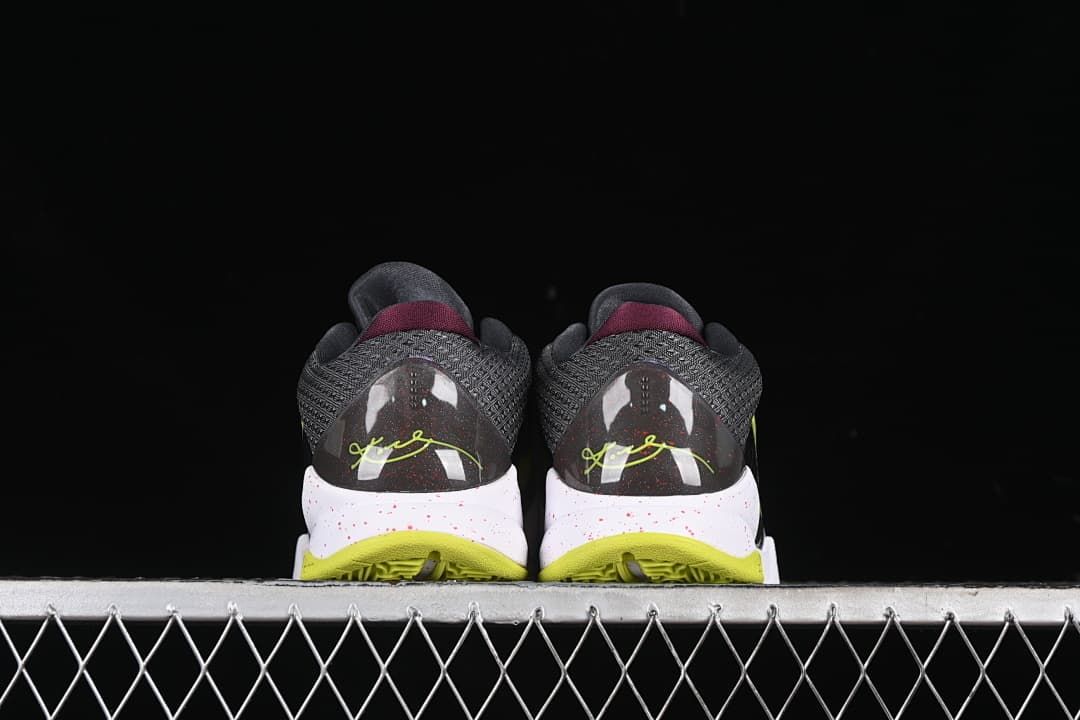 Rear view of the pair, showing the heel graphics and yellow-green outsoles.