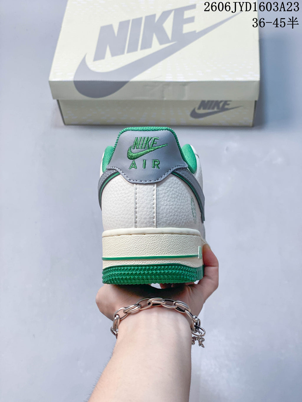 Rear view showing the white heel, gray heel tab, and green outsole.