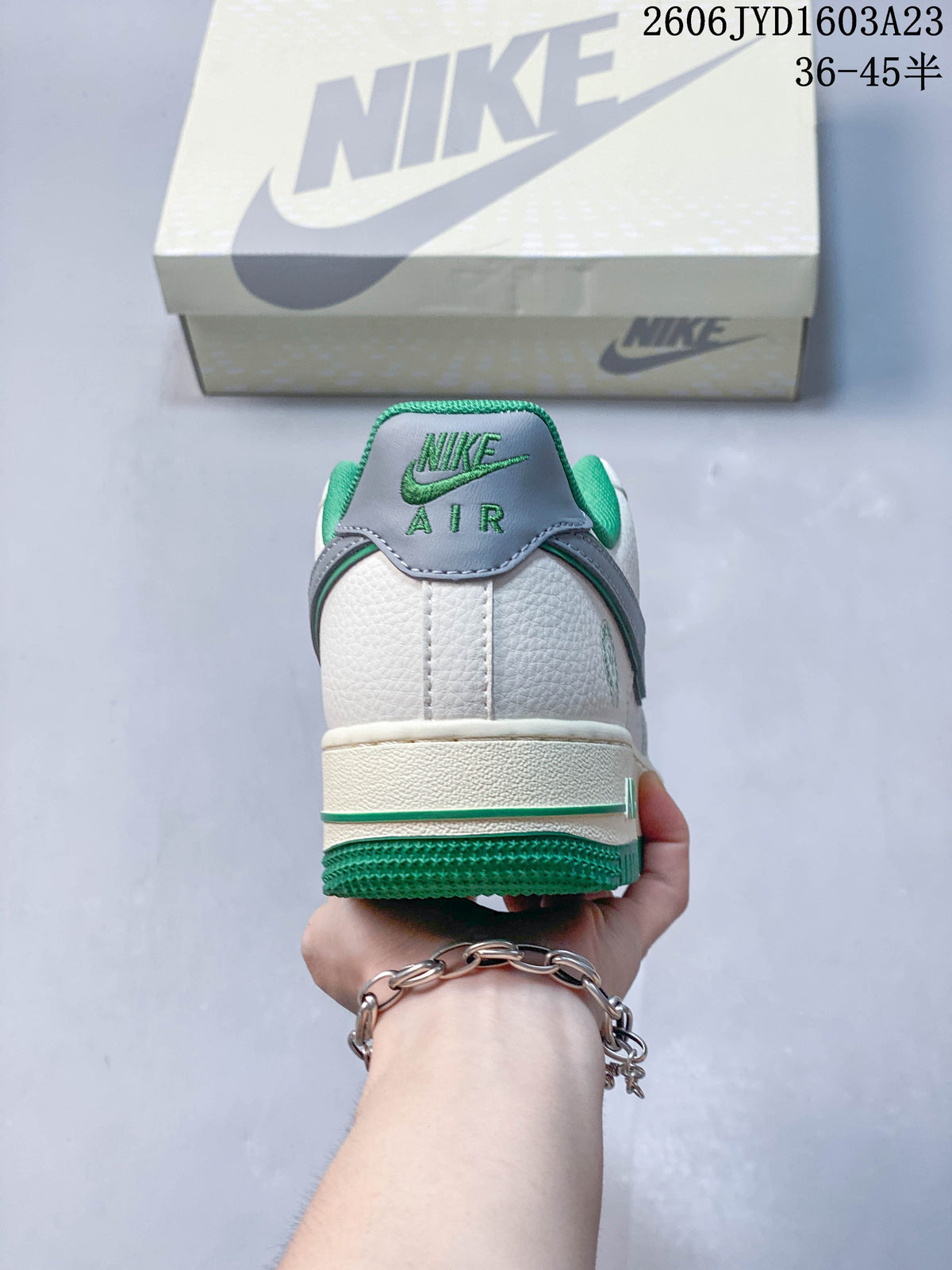 Rear view showing the white heel, gray heel tab, and green outsole.