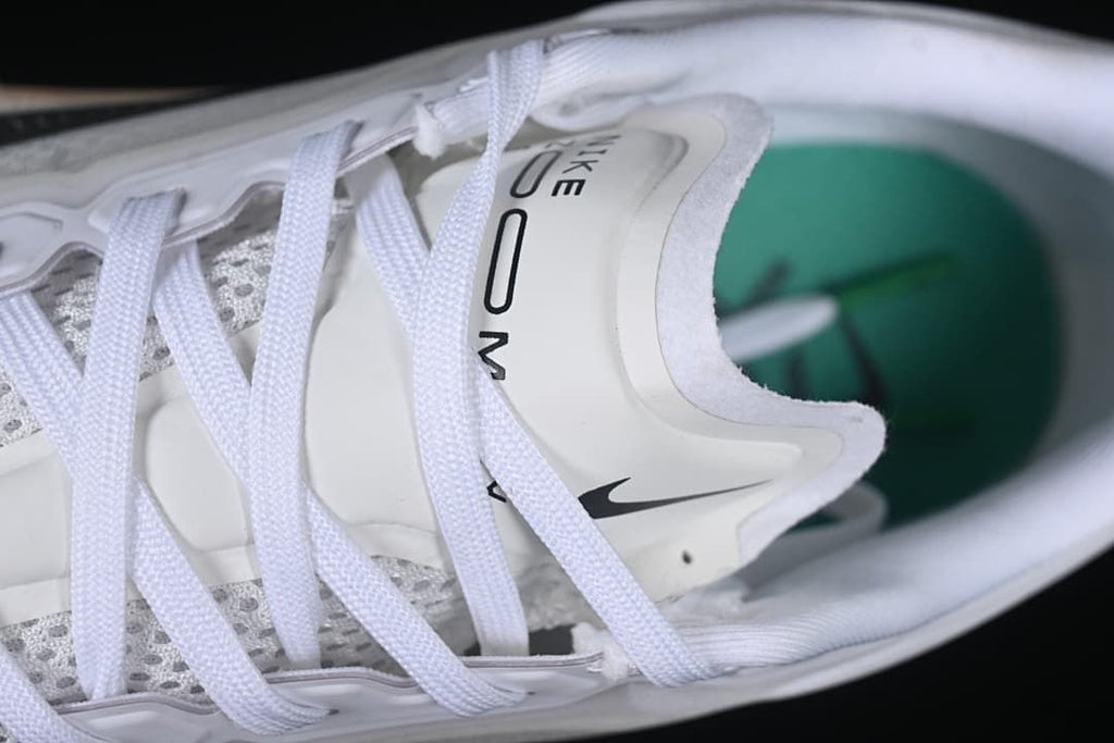 Close-up of the tongue, laces and teal-colored insole