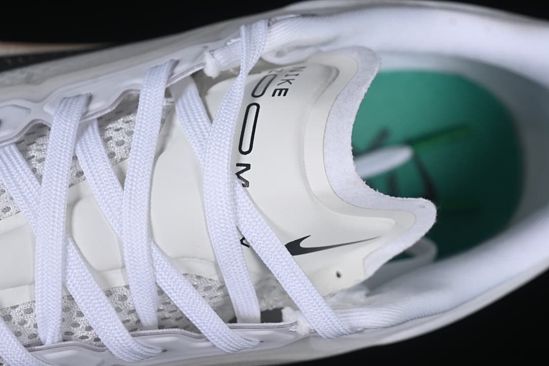 Close-up of the tongue, laces and teal-colored insole
