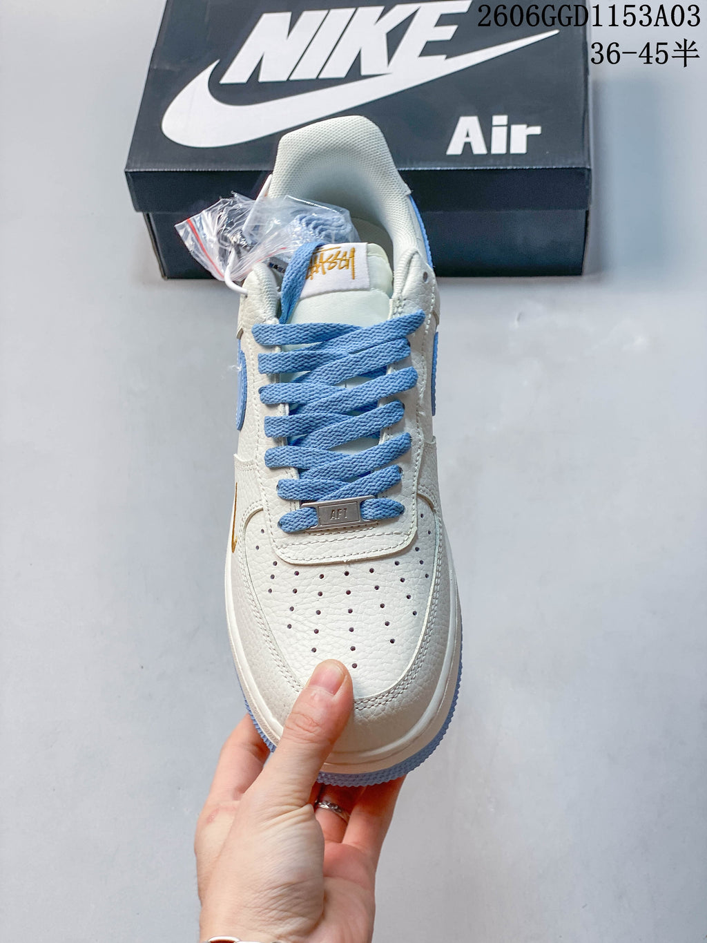Front view showing the perforated toe, blue laces and off-white upper