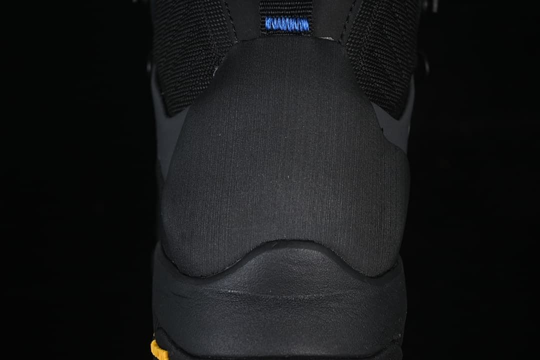 Rear view showing the heel and pull tab of the black hiking boot