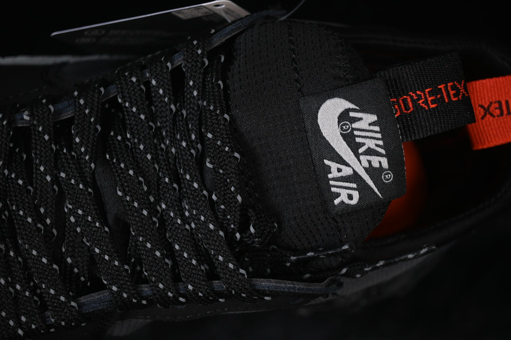Close-up of the tongue, reflective-pattern laces, and Gore-Tex-branded pull tab