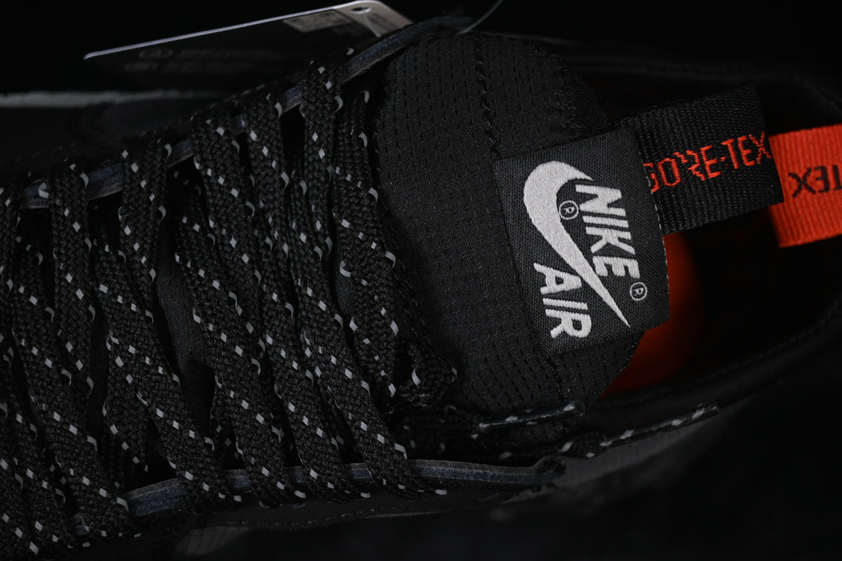 Close-up of the tongue, reflective-pattern laces, and Gore-Tex-branded pull tab