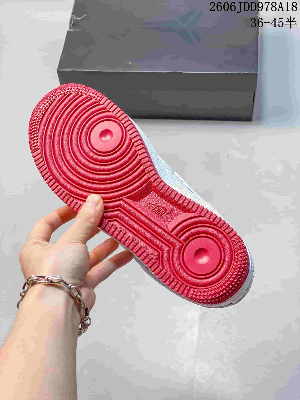 Red outsole of the white Nike Air Force 1 sneaker