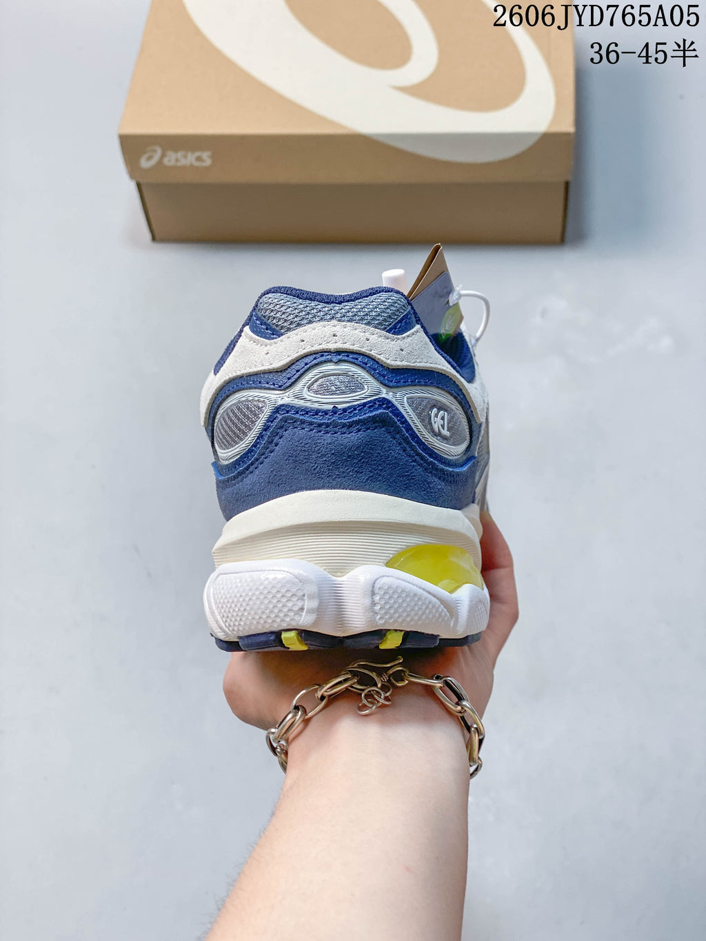 Rear view of the sneakers, with blue and white panels and yellow sole accents.