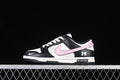 Side view of a black, white, and pink Nike SB Dunk Low with a bow accent