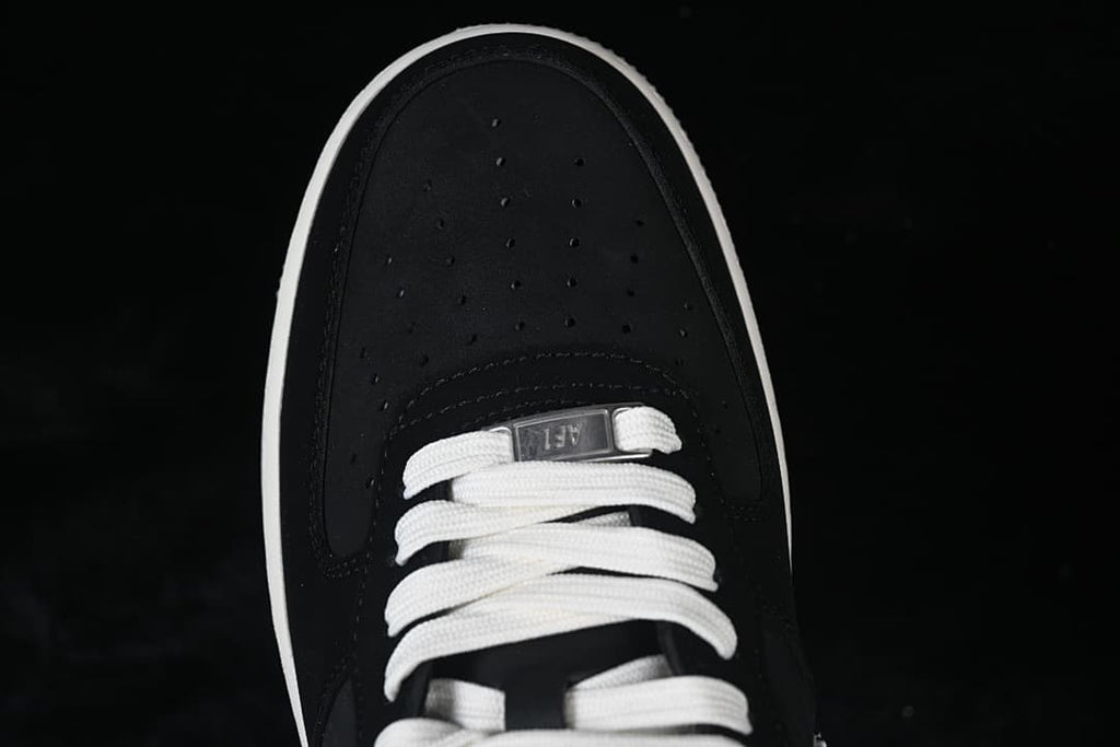 Top view of the perforated black toe and white laces