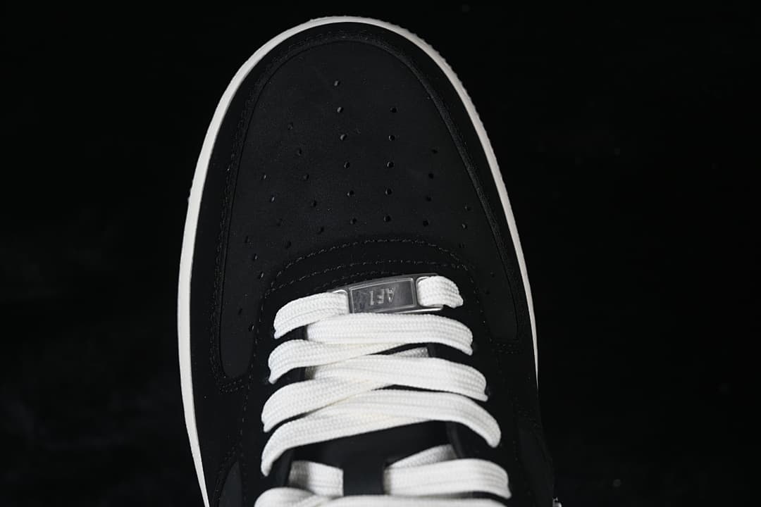 Top view of the perforated black toe and white laces