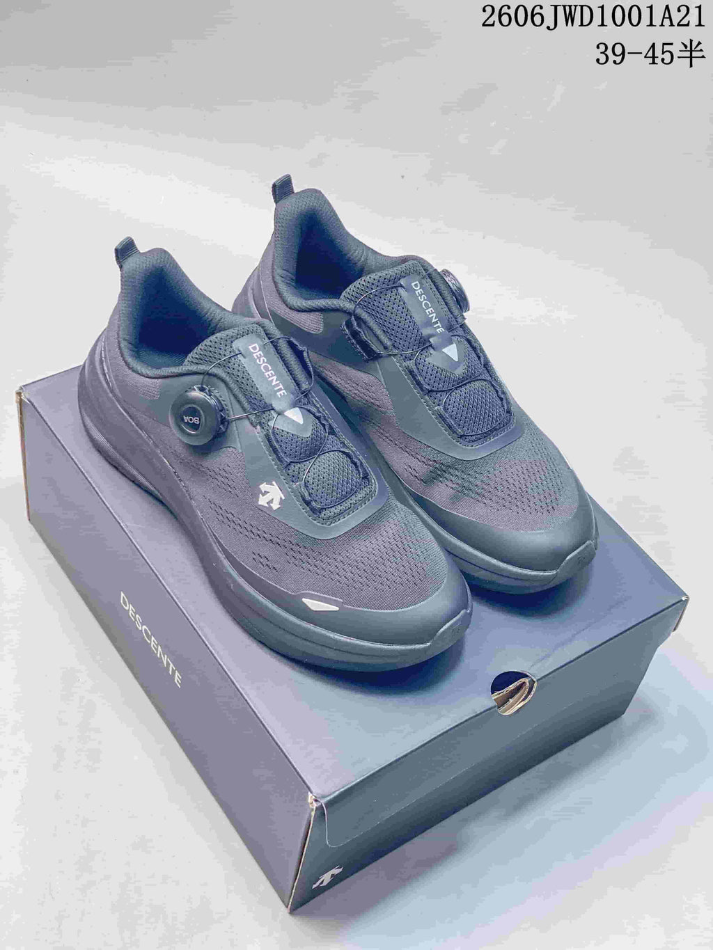 Pair of dark gray DESCENTE LAVITATE WIRE sneakers with dial closures, shown on a branded box