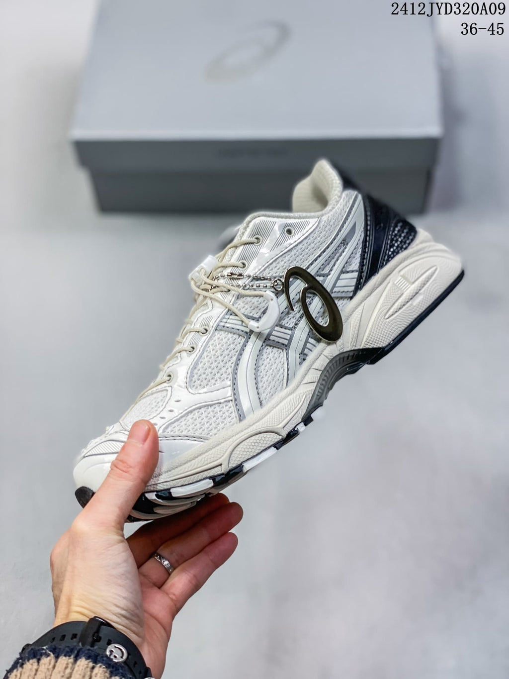 Side view of the off-white and silver sneaker with mesh panels and dark accents.