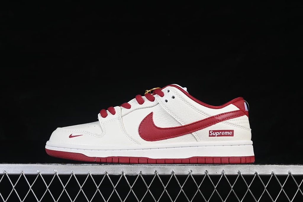 Side view of an off-white and red low-top Nike SB Dunk with a red Swoosh and outsole