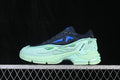 Side view of navy and mint Raf Simons Pharaxus low-top sneakers with blue and green accents