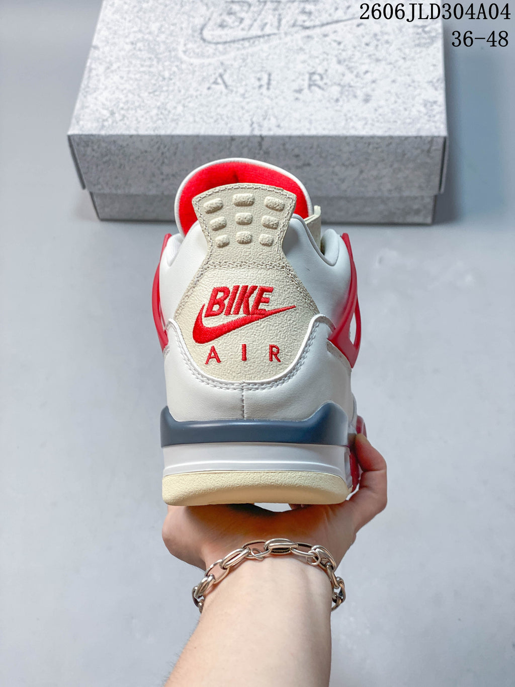 Rear view of the sneaker with red heel branding and grey detailing