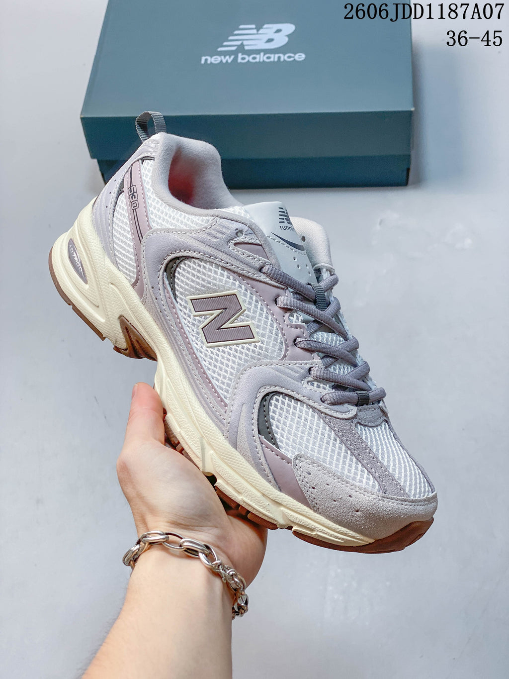 Angled side view highlighting the sneaker's mesh upper and layered overlays