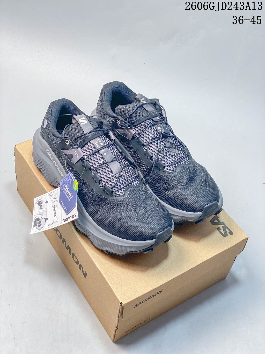 Pair of dark gray Salomon Ultra Glide 4 trail running shoes on a branded shoe box.