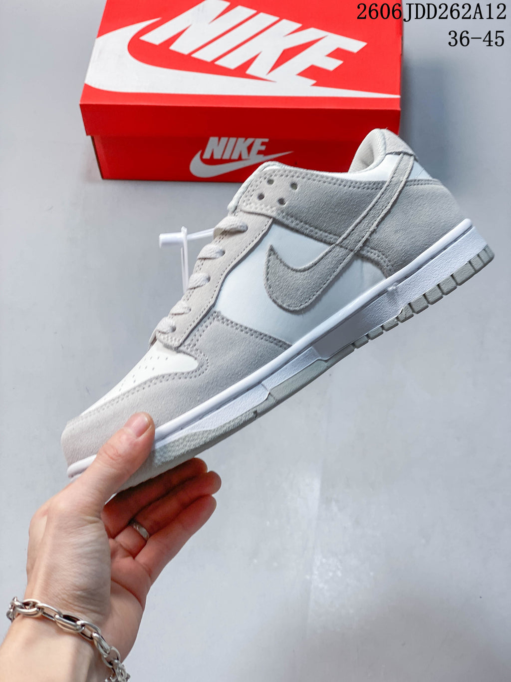 Side view highlighting the small grey Swoosh and Sail-colored panels.