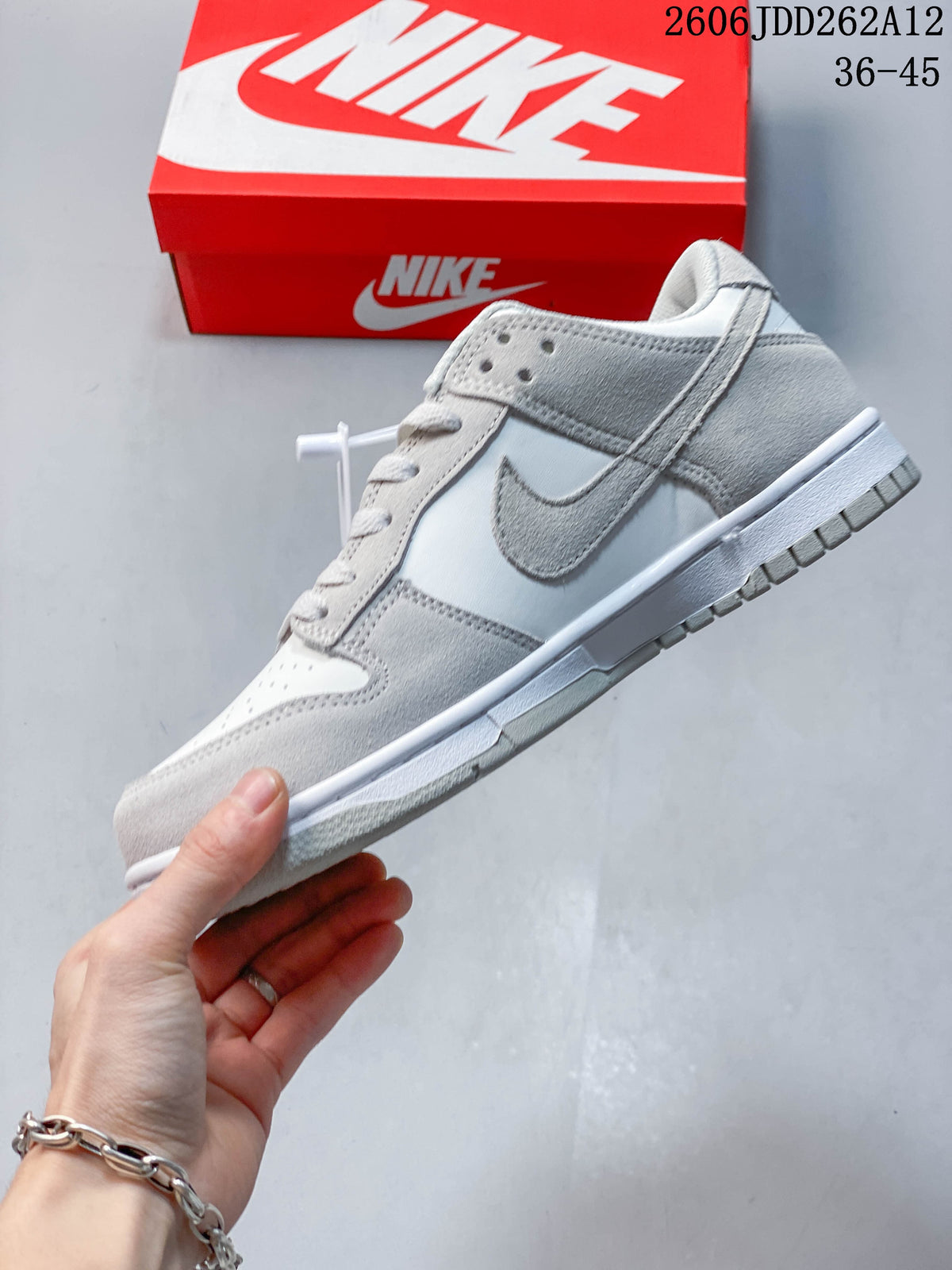 Side view highlighting the small grey Swoosh and Sail-colored panels.