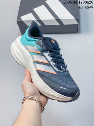 Dark navy training shoe with teal and orange accents and a light-colored sole; box label shows 40–45.