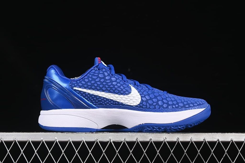 Side profile of blue shoe with white Swoosh and white midsole