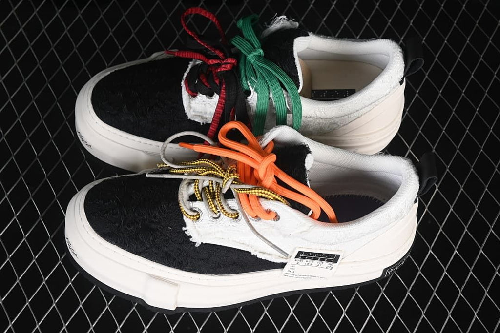 Pair of white and black platform sneakers with contrasting laces