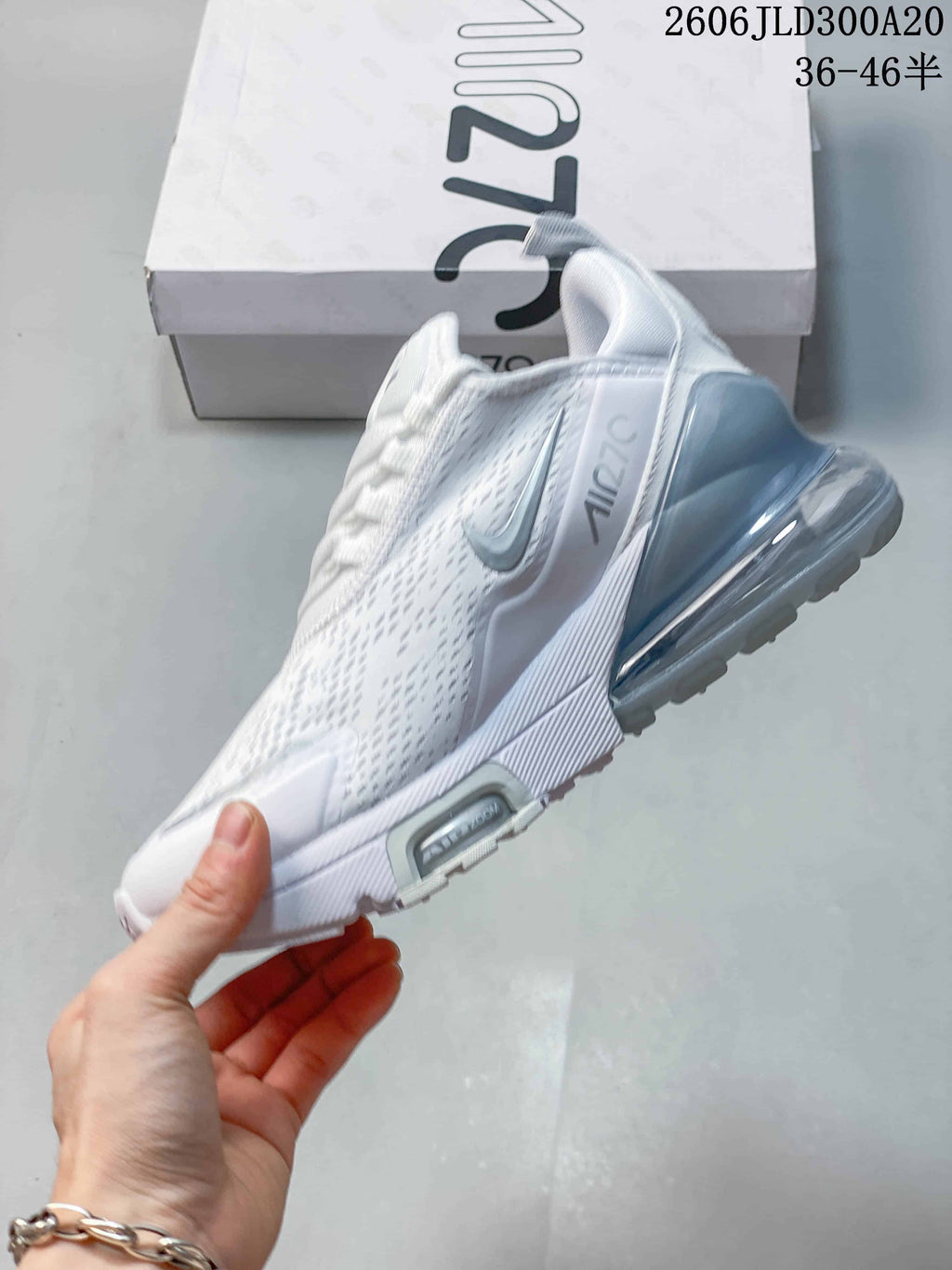 Side profile of a white Nike Air Max 270 Premium sneaker with a visible heel unit