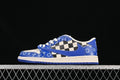 Side view of a blue and off-white low-top sneaker with checkerboard panel and patterned overlays