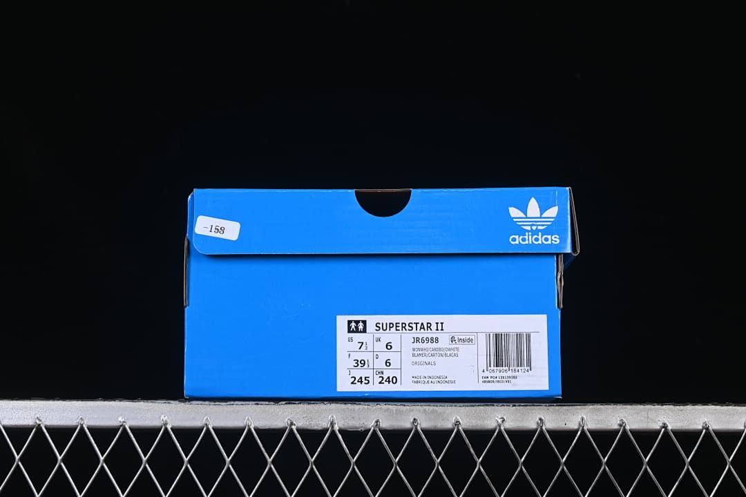 Blue adidas shoe box label identifying Superstar II and JR6988, with sample size information.