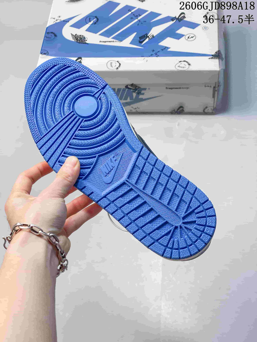 Blue outsole of the low-top sneaker, showing its circular tread pattern.