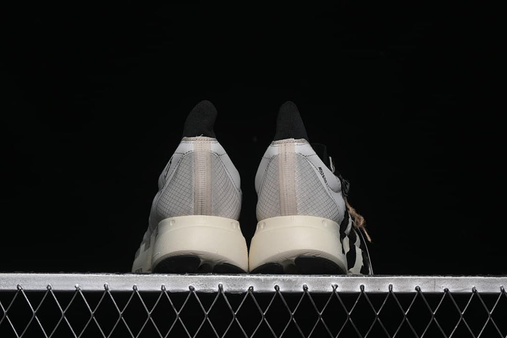 Rear view of the pair showing patterned heels and off-white soles