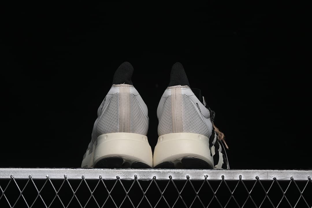 Rear view of the pair showing patterned heels and off-white soles