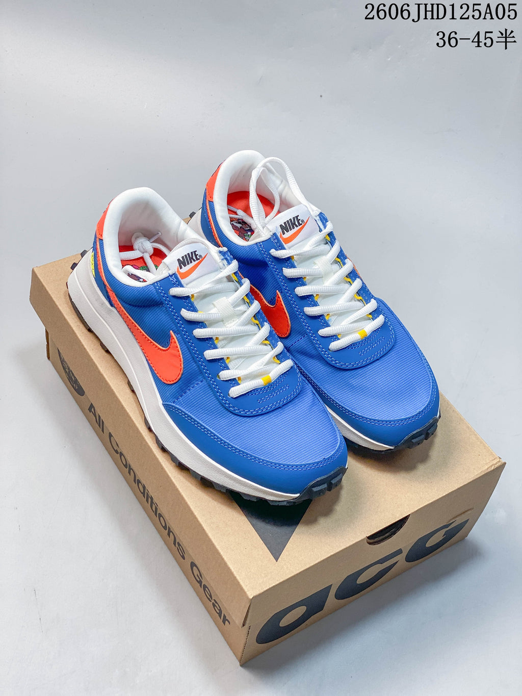 Pair of bright blue Nike ACG LDV sneakers with orange accents