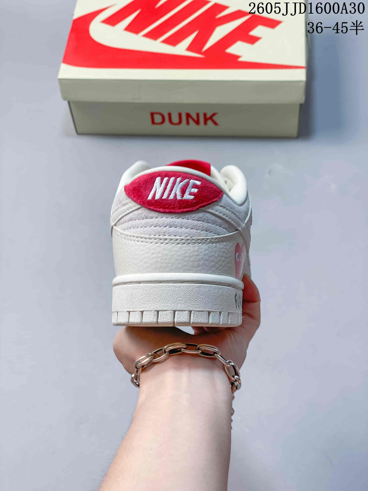 Rear view of an off-white low-top sneaker with a red heel tab