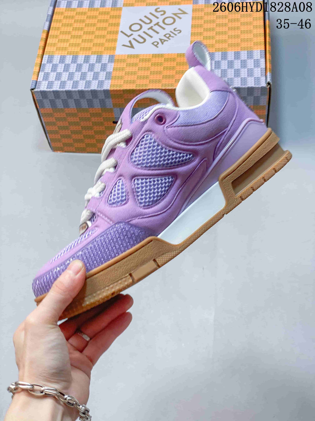 Side profile of a lavender sneaker with mesh panels and a gum-colored sole