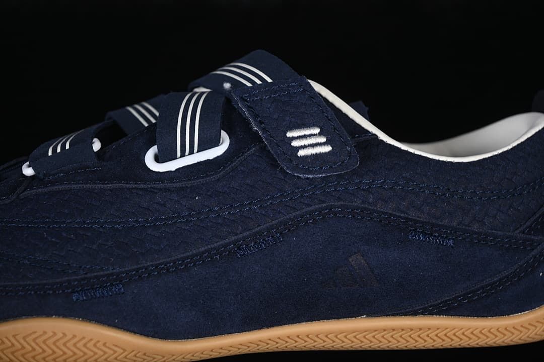 Close-up of the navy upper, striped straps, and white strap loops.