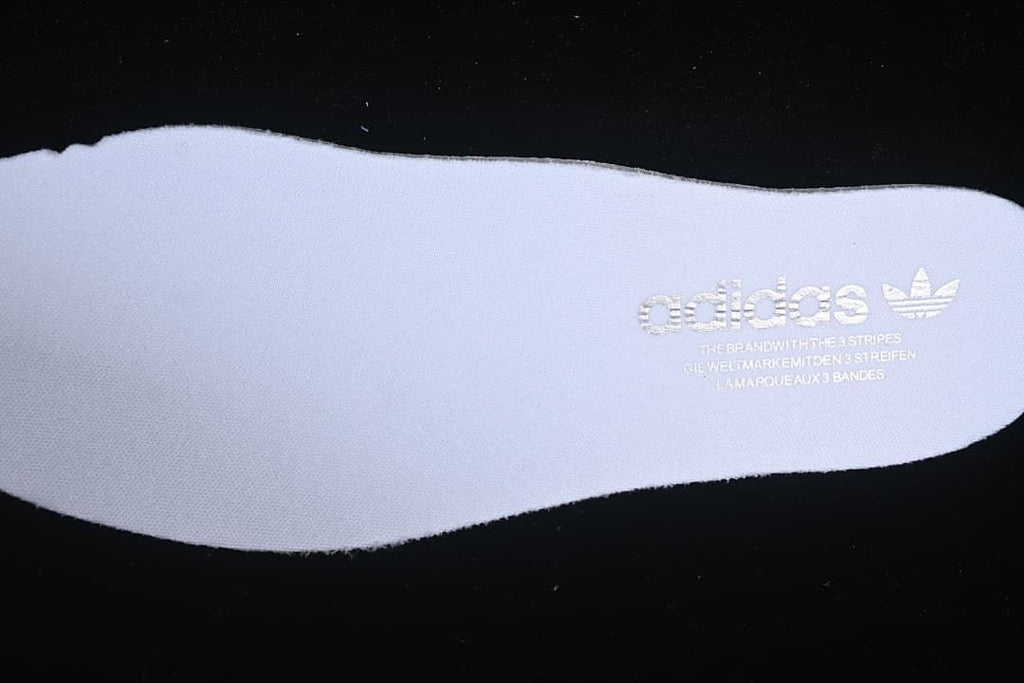 Close-up of a white insole with Adidas branding