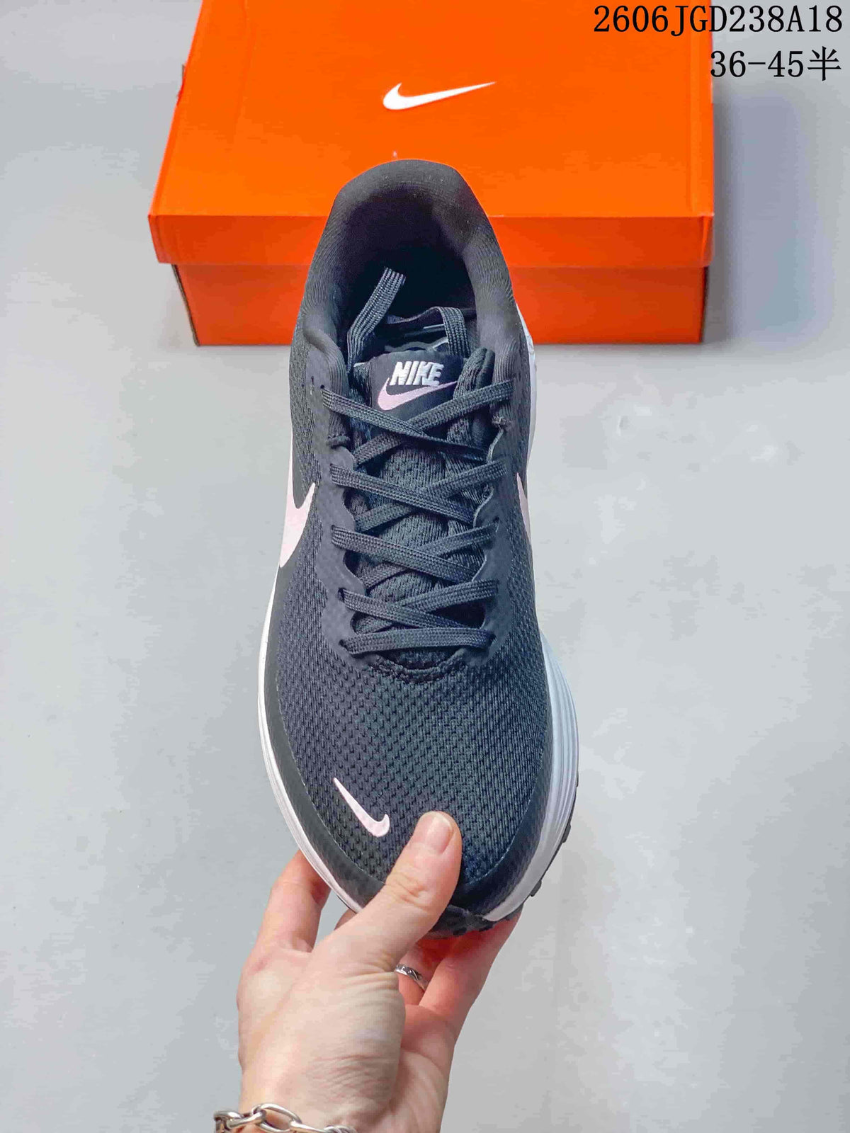 Top view of the lace-up shoe with charcoal upper and pale pink accents