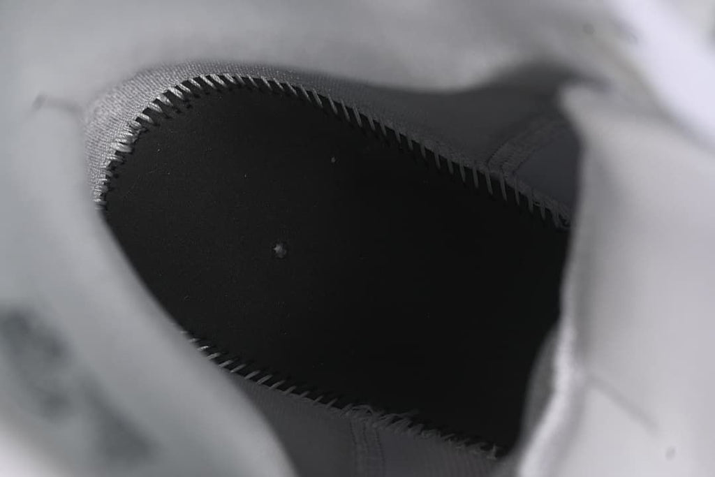 View inside the shoe showing the dark footbed and stitched lining